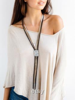 Statement necklace, Leather necklace, Long necklace, Wrapped necklace, Stylish necklace, Silver necklace, Elegant necklace, Large necklace.