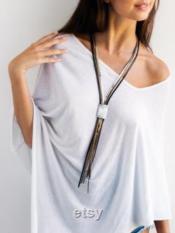 Statement necklace, Leather necklace, Long necklace, Wrapped necklace, Stylish necklace, Silver necklace, Elegant necklace, Large necklace.