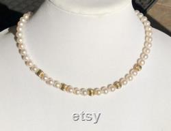 Strand of white pearls with gold accent beads